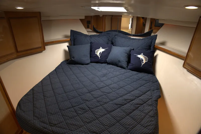 Blueprint Yacht Photos Pics Cozy cabin interior of 2002 Viking 43 Open yacht with blue bedding and marlin pillows.