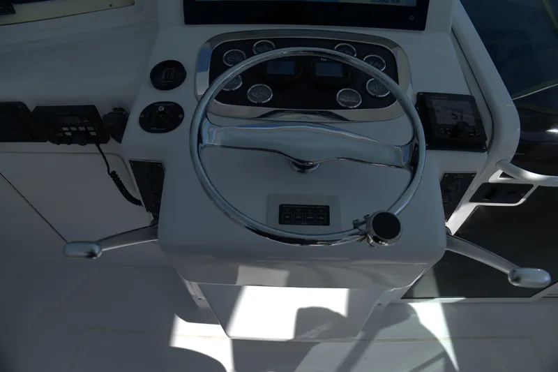 Blueprint Yacht Photos Pics Steering console of 2002 Viking 43 Open boat with chrome wheel and control panel.