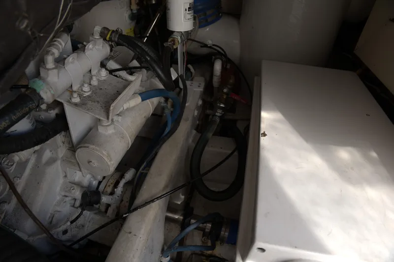 Blueprint Yacht Photos Pics Engine compartment of a 2002 Viking 43 Open boat, showcasing mechanical components and hoses.