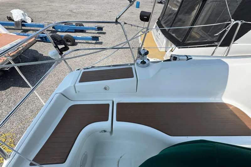  Yacht Photos Pics Deck view of 2007 Beneteau Oceanis Clipper 373 sailboat with wooden seating area.