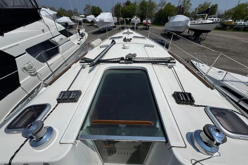  Yacht Photos Pics Deck view of a 2007 Beneteau Oceanis Clipper 373 sailboat in a marina.