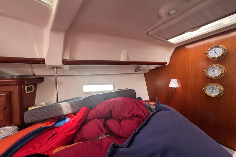  Yacht Photos Pics Cozy cabin interior of 2007 Beneteau Oceanis Clipper 373 sailboat with bedding and instruments.