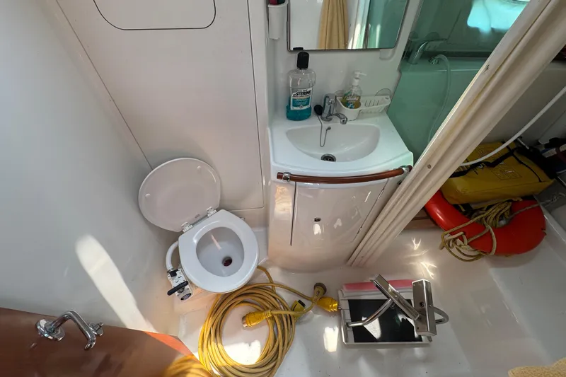  Yacht Photos Pics Bathroom of 2007 Beneteau Oceanis Clipper 373 yacht with toilet, sink, and safety equipment.