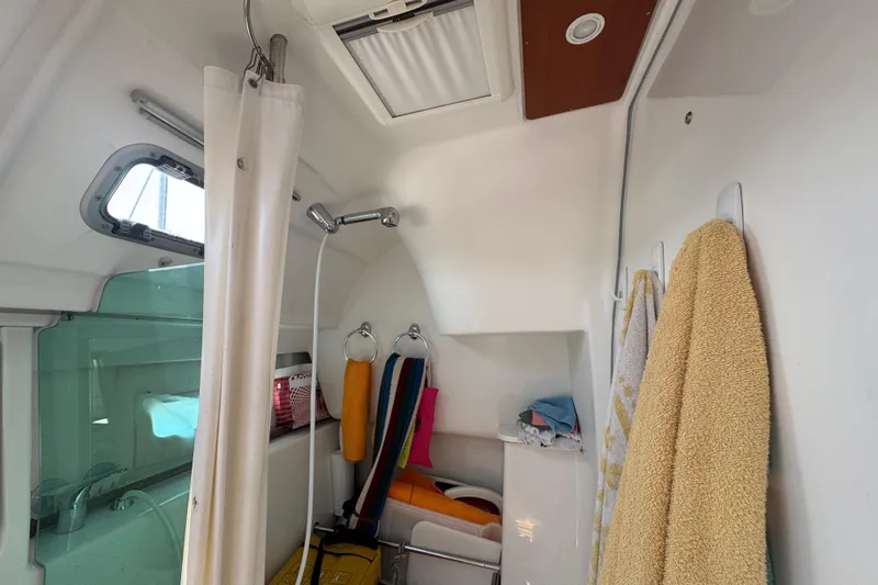  Yacht Photos Pics Interior of 2007 Beneteau Oceanis Clipper 373, featuring a compact bathroom with shower and towels.
