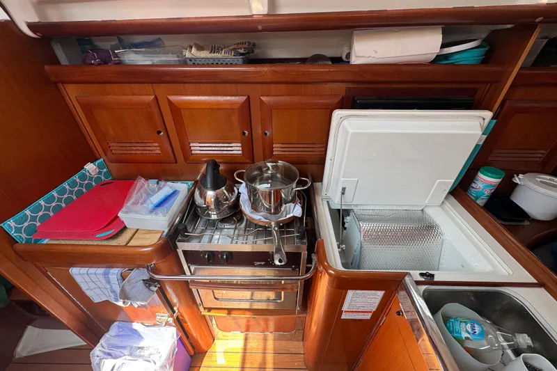  Yacht Photos Pics Galley kitchen in 2007 Beneteau Oceanis Clipper 373 sailboat with stove and storage.