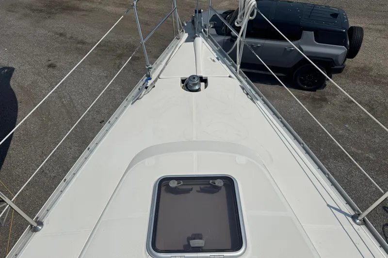  Yacht Photos Pics Deck view of 2007 Beneteau Oceanis Clipper 373 sailboat, parked beside a vehicle.