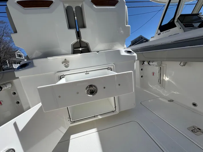  Yacht Photos Pics 2025 Pursuit S 268 boat interior, featuring storage compartments and sleek design elements.