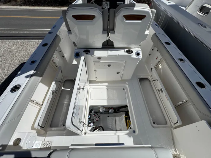  Yacht Photos Pics 2025 Pursuit S 268 boat interior with open storage compartments and seating.