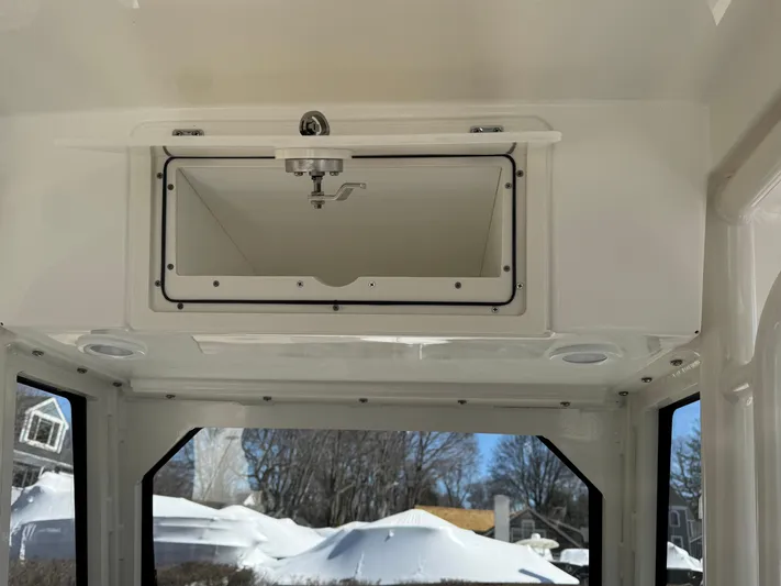  Yacht Photos Pics 2025 Pursuit S 268 boat interior with open storage compartment, showcasing sleek design and functionality.