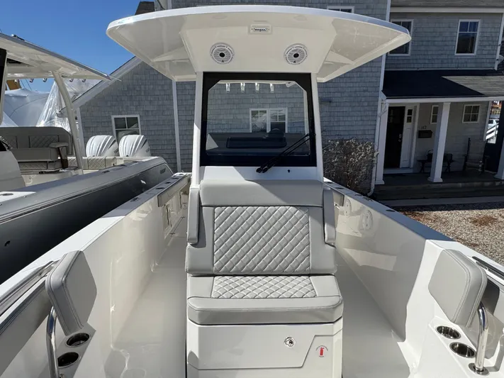  Yacht Photos Pics 2025 Pursuit S 268 boat with sleek seating and modern design in a marina setting.