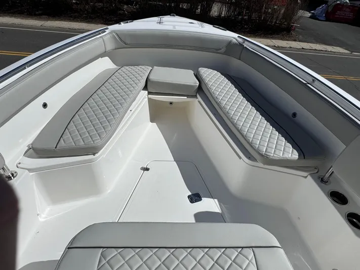  Yacht Photos Pics 2025 Pursuit S 268 boat interior with cushioned seating and sleek design.