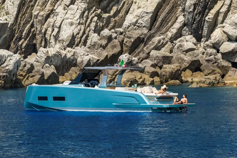  Yacht Photos Pics 2026 Pardo Yachts P43 cruising near rocky cliffs with people relaxing on deck.