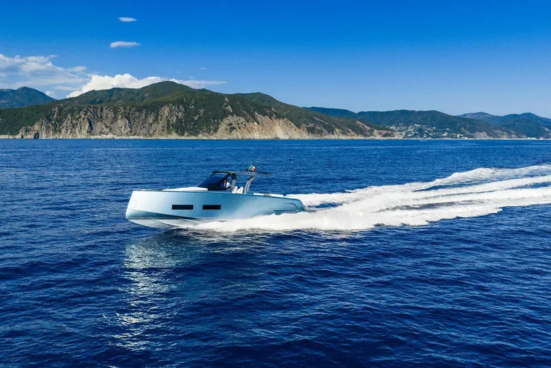  Yacht Photos Pics 2026 Pardo Yachts P43 cruising on blue ocean with scenic mountain backdrop.