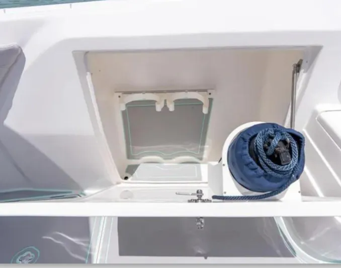  Yacht Photos Pics 2023 Intrepid 375 boat storage compartment with coiled rope and hatch.
