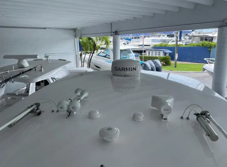  Yacht Photos Pics 2023 Intrepid 375 boat with Garmin equipment, docked under a covered area.