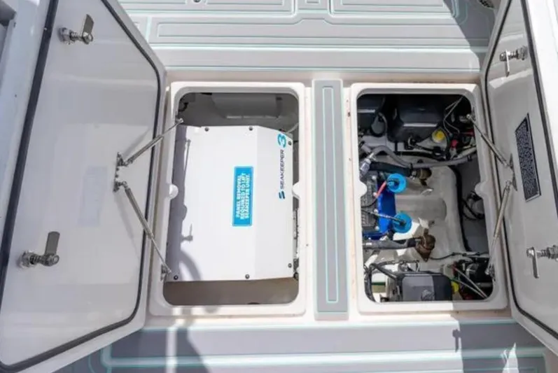  Yacht Photos Pics 2023 Intrepid 375 boat engine compartment with open hatches, showcasing mechanical components.