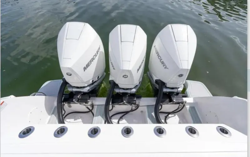  Yacht Photos Pics Triple Mercury outboard engines on a 2023 Intrepid 375 boat, docked on water.