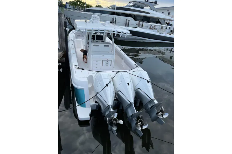  Yacht Photos Pics 2023 Intrepid 375 boat docked with triple outboard engines, viewed from above.