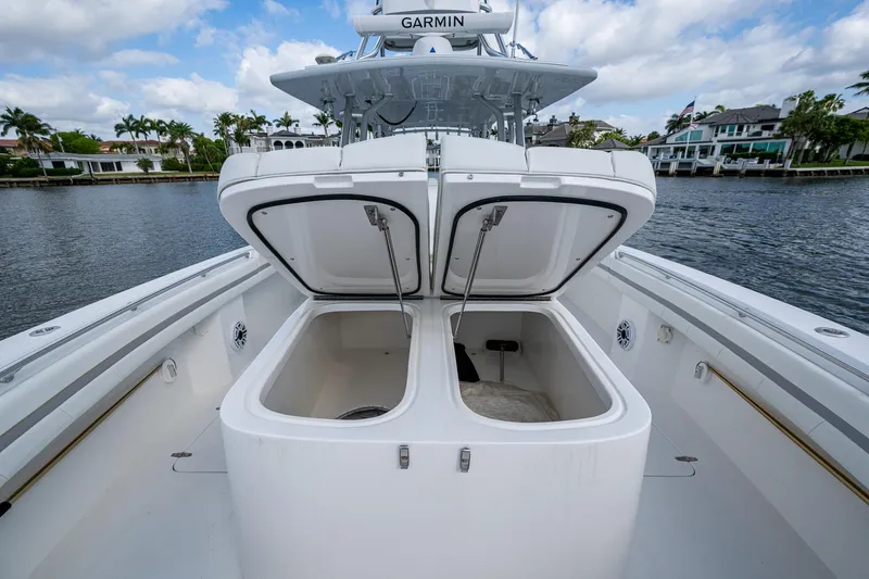  Yacht Photos Pics 2023 Prowler Renaissance 36 boat with open storage compartments on a calm waterway.