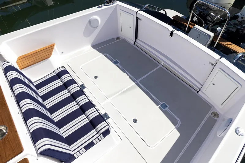 Dealer Demo Yacht Photos Pics 2020 True North 34 boat cockpit with striped seating and storage compartments.