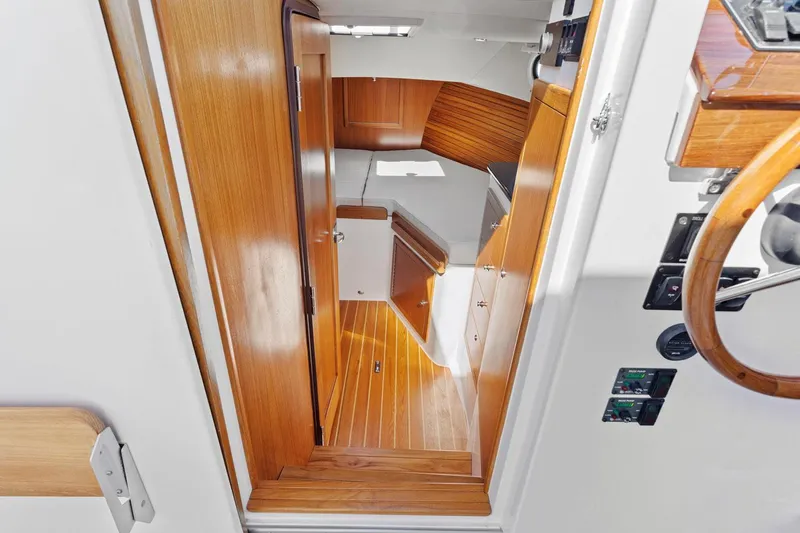 Dealer Demo Yacht Photos Pics Interior view of 2020 True North 34 boat with wooden finishes and compact cabin space.