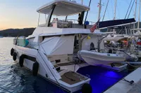 2020 Leopard 43 Powercat docked at sunset with illuminated blue underwater lights.