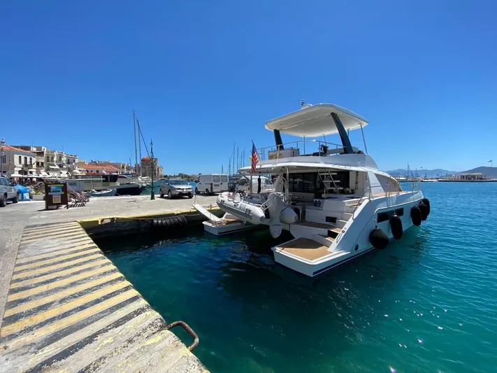  Yacht Photos Pics Leopard 43 Powercat 2020 docked at a sunny marina with clear blue water.