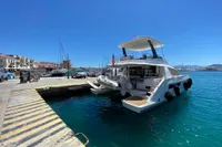 Leopard 43 Powercat 2020 docked at a sunny marina with clear blue water.