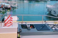 Leopard 43 Powercat 2020 yacht with outdoor kitchen, docked in a marina.