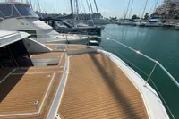 2020 Leopard 43 Powercat docked, showcasing spacious deck and marina view.