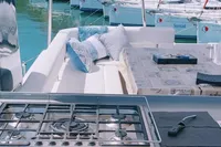 Leopard 43 Powercat 2020 yacht with outdoor kitchen and seating area in marina.