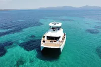Leopard 43 Powercat 2020 cruising on clear turquoise waters with distant mountains.
