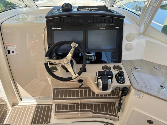  Yacht Photos Pics 2018 Boston Whaler 350 Realm helm with dual Raymarine displays and modern controls.