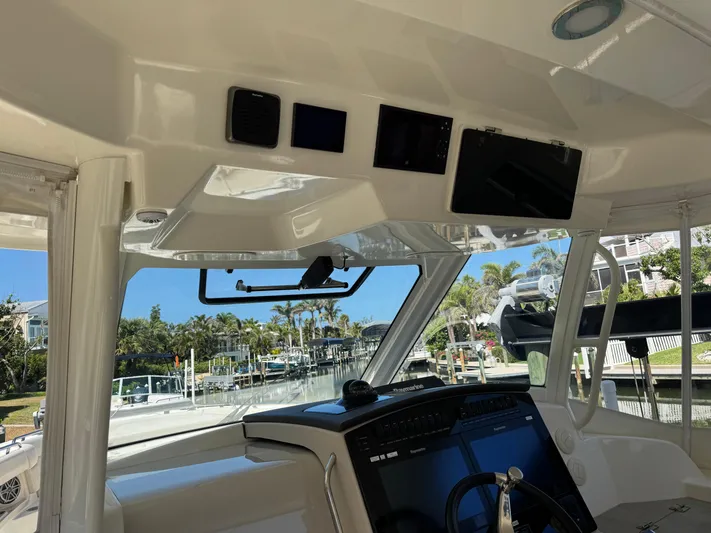  Yacht Photos Pics Interior view of 2018 Boston Whaler 350 Realm boat cockpit with navigation equipment.