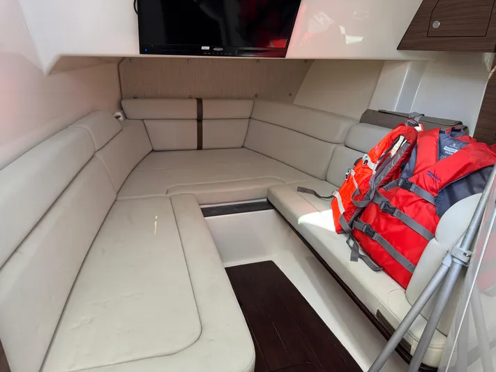  Yacht Photos Pics Interior of 2018 Boston Whaler 350 Realm with seating, TV, and life jackets.