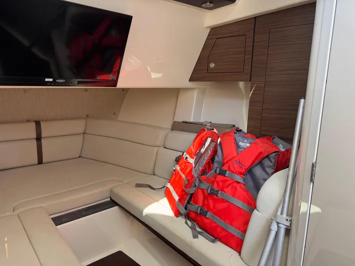  Yacht Photos Pics Interior of 2018 Boston Whaler 350 Realm with life jackets and TV.