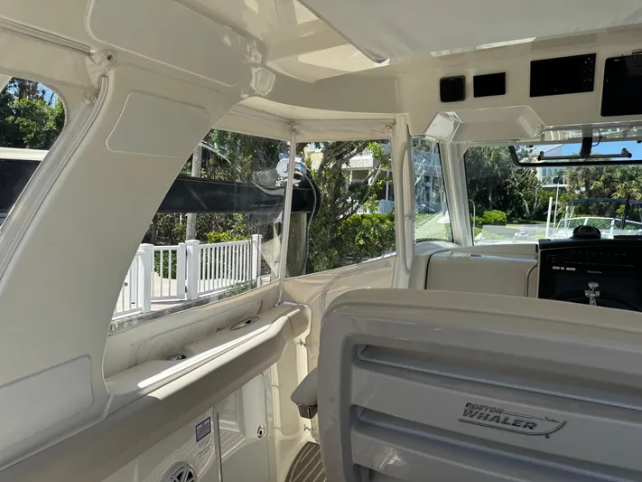  Yacht Photos Pics Interior view of 2018 Boston Whaler 350 Realm boat, showcasing helm and seating area.