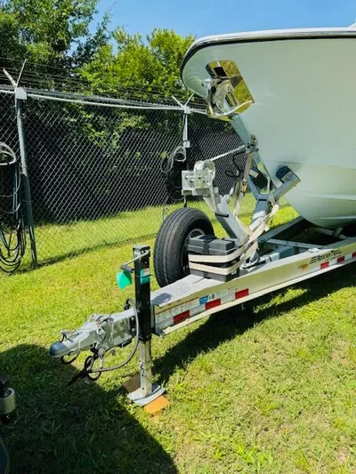  Yacht Photos Pics 2022 Invincible 36 Open Fisherman boat on trailer, parked on grass.