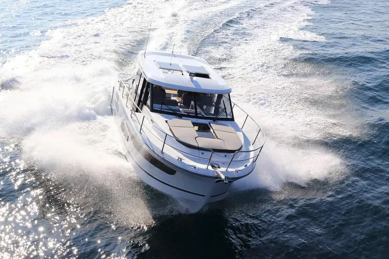  Yacht Photos Pics Manufacturer Provided Image: 2020 Jeanneau NC 1095 motorboat cruising on open water.