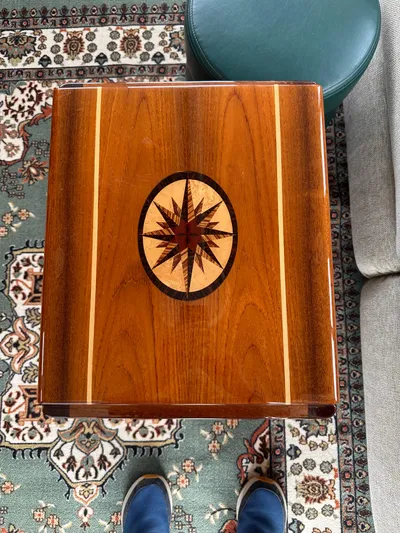 River Miss Yacht Photos Pics Wooden table with compass rose inlay, on patterned rug, Mainship 350, 1997.