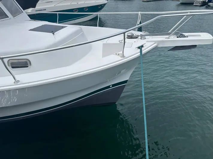 River Miss Yacht Photos Pics 1997 Mainship 350 boat docked on calm water, featuring sleek white hull and railing.