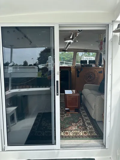 River Miss Yacht Photos Pics 1997 Mainship 350 yacht interior with sliding glass door, cozy seating, and nautical decor.