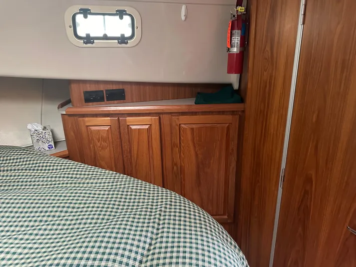 River Miss Yacht Photos Pics Interior of 1997 Mainship 350 with wood cabinets, bed, and window.