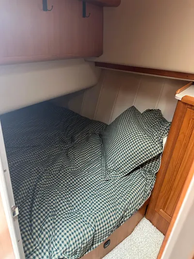 River Miss Yacht Photos Pics 1997 Mainship 350 cabin interior with cozy bed and checkered bedding.