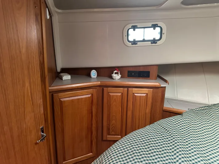 River Miss Yacht Photos Pics Interior of 1997 Mainship 350 boat with wooden cabinets and small window.