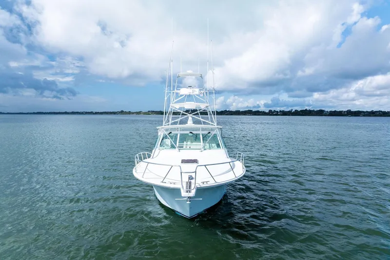 Pescador Yacht Photos Pics 2004 Cabo 40 Hardtop Express yacht on open water under cloudy sky.