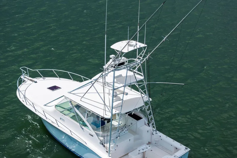 Pescador Yacht Photos Pics 2004 Cabo 40 Hardtop Express boat on water, featuring a sleek design and fishing tower.