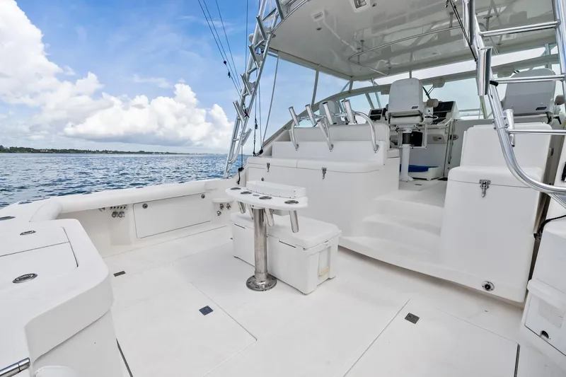 Pescador Yacht Photos Pics 2004 Cabo 40 Hardtop Express yacht deck with seating and fishing rod holders.