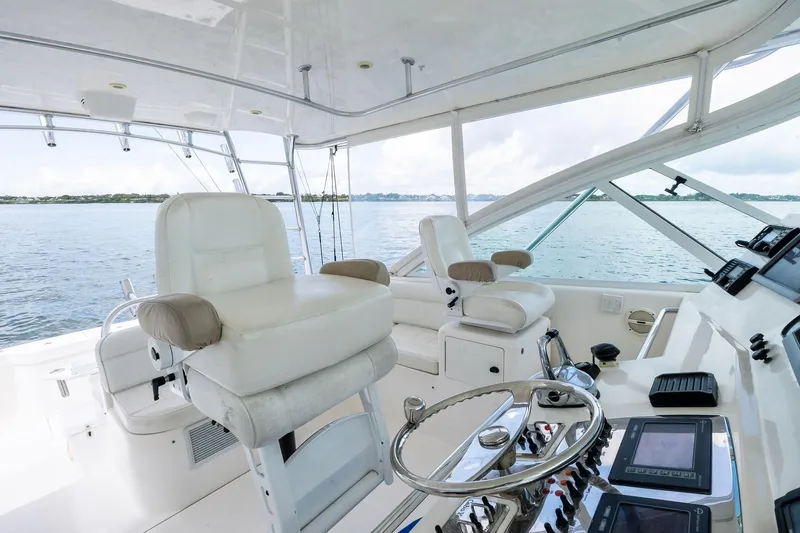 Pescador Yacht Photos Pics 2004 Cabo 40 Hardtop Express yacht interior with helm, white seating, and ocean view.