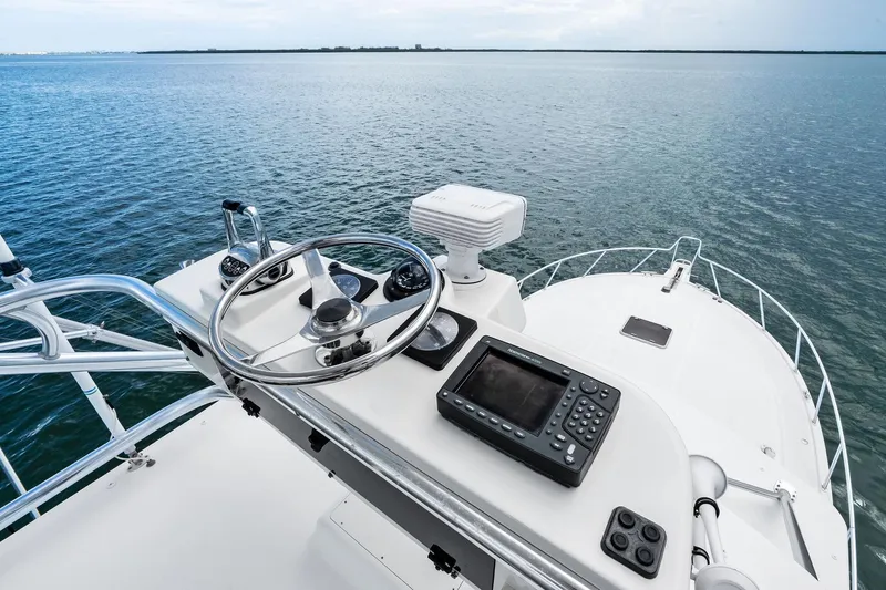 Pescador Yacht Photos Pics 2004 Cabo 40 Hardtop Express helm with ocean view, featuring navigation equipment.